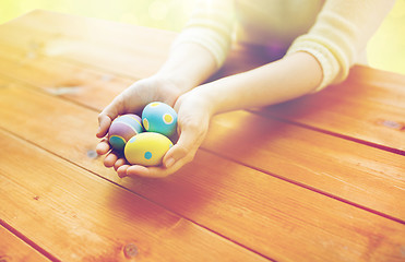 Image showing close up of woman hands with colored easter eggs