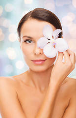 Image showing beautiful young woman with orchid flower