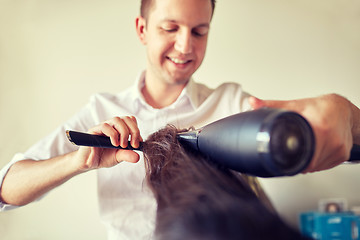 Image showing  close up of stylist making hairdo at salon