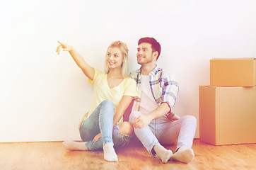 Image showing couple with boxes moving to new home and dreaming