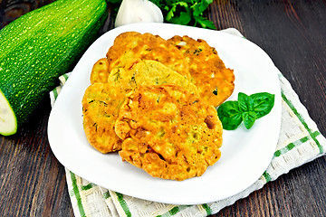Image showing Flapjack chickpeas with zucchini in plate on dark board