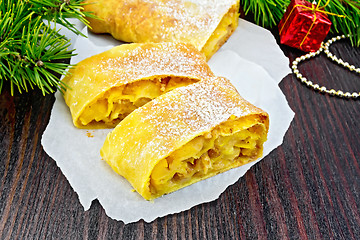 Image showing Strudel pumpkin and apple with pine branches on wooden board