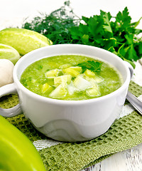 Image showing Soup cucumber with parsley in white bowl on board