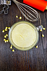 Image showing Flour corn in glass cup on board top