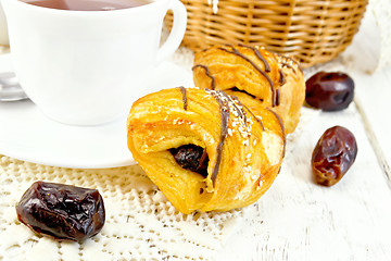 Image showing Cookies with dates and tea in white cup on board