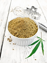 Image showing Flour hemp in bowl with leaf on board