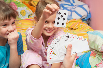 Image showing Children happily pull the card from the card fan