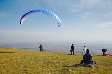 Image showing Paraglider preparing for takeoff