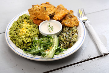 Image showing Oyster topped with bread crumbs a puree of green peas 