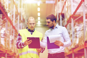 Image showing worker and businessmen with clipboard at warehouse