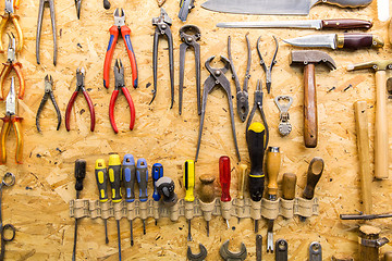 Image showing work tools hanging on wall at workshop