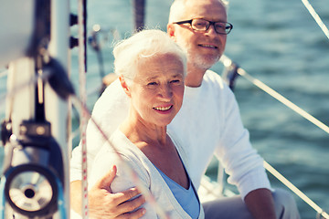 Image showing senior couple hugging on sail boat or yacht in sea