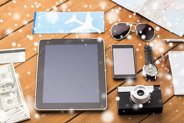 Image showing tablet pc, smartphone, airplane ticket and camera