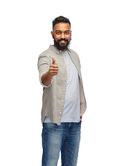 Image showing happy indian man showing thumbs up over white