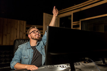 Image showing man at mixing console in music recording studio