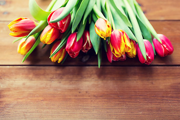 Image showing close up of tulip flowers on wooden table