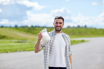 Image showing man or farmer with jug of milk at countryside