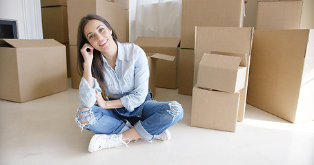 Image showing Happy young woman chatting on her mobile