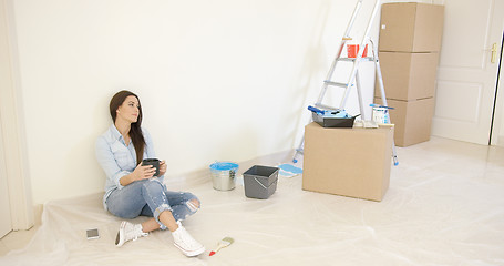 Image showing Tired young woman relaxing during renovations