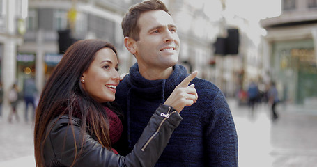 Image showing Attractive young woman pointing out something