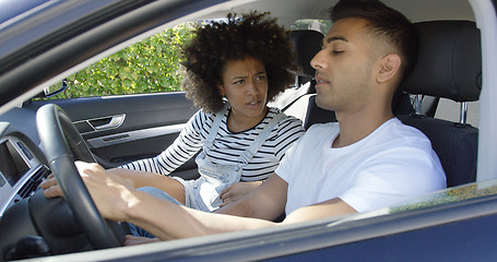 Image showing Young couple having a serious talk in a car