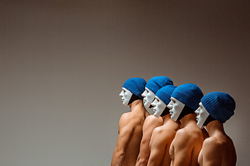 Image showing The group of caucasian men in white masks and hats, jeans