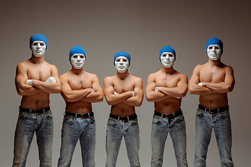 Image showing The group of caucasian men in white masks and hats, jeans