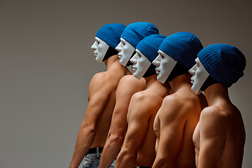 Image showing The group of caucasian men in white masks and hats, jeans