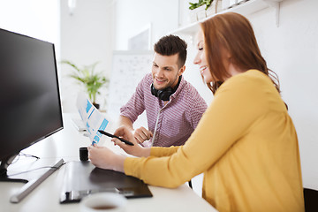 Image showing happy creative team with papers at office