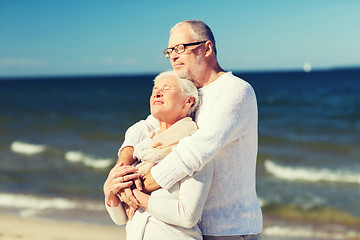 Image showing happy senior couple hugging on summer beach