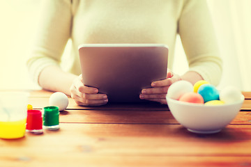 Image showing close up of woman with tablet pc and easter eggs