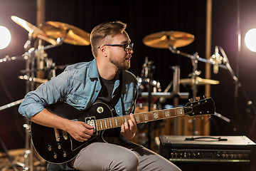 Image showing man playing guitar at studio rehearsal