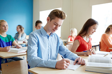 Image showing group of students with books writing school test