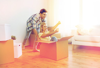 Image showing happy couple having fun with boxes at new home