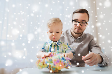 Image showing father and son playing with ball clay at home