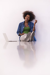 Image showing african american woman sitting on floor with laptop