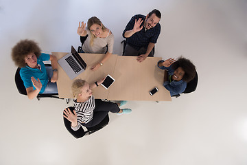 Image showing Multiethnic startup business team on meeting  top view