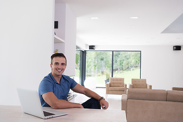 Image showing Young man with laptop at home