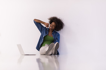 Image showing african american woman sitting on floor with laptop