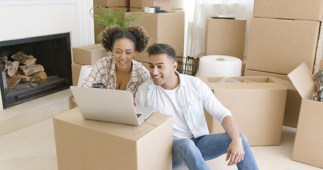 Image showing Happy couple using laptop in their new apartment