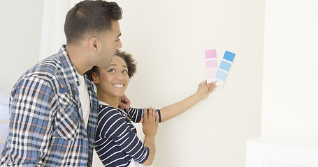 Image showing Young couple choosing a paint color