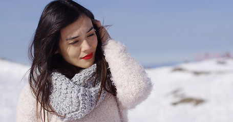 Image showing Pretty young woman in sweater on ski slope