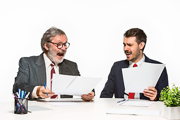 Image showing The two colleagues working together at office on white background.