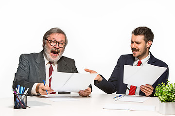 Image showing The two colleagues working together at office on white background.