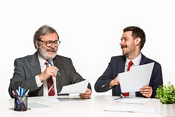 Image showing The two colleagues working together at office on white background.