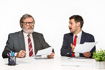 Image showing The two colleagues working together at office on white background.