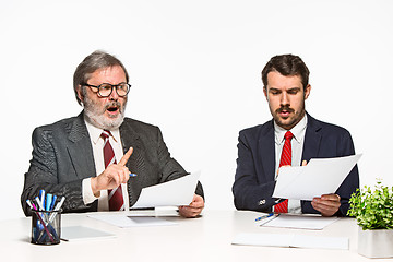 Image showing The two colleagues working together at office on white background.