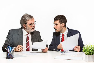 Image showing The two colleagues working together at office on white background.