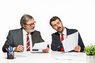 Image showing The two colleagues working together at office on white background.