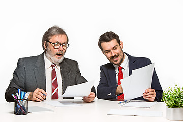 Image showing The two colleagues working together at office on white background.